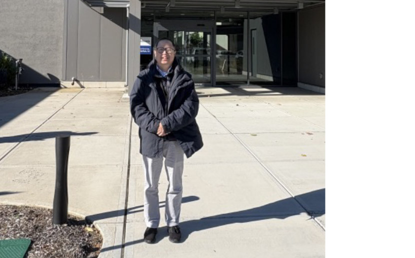 Photo of Ben Yeoh standing outside of the lab